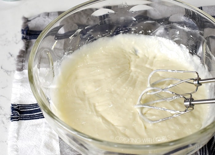Cream cheese and coconut cream blended together in a large glass bowl 
