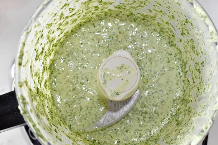 Creamy cilantro lime dressing in the bowl of a food processor