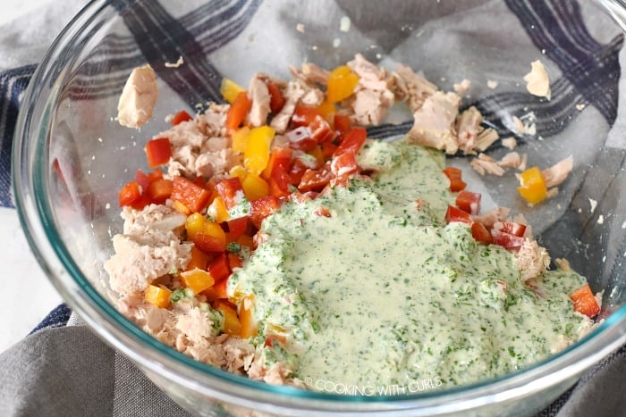 Tuna, chopped bell pepper and cilantro lime dressing in a mixing bowl