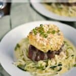 Image of Crab Cake topped Filet Mignon with lemon-garlic cream sauce on a bed of zucchini noodles with name graphic
