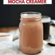 Peppermint mocha creamer in a mason jar with a cup of coffee in the background and title graphic across the top.