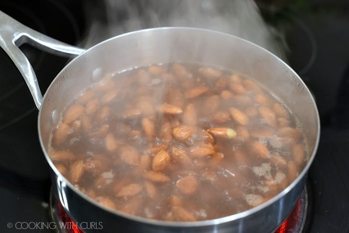 Raw almonds boiled in a saucepan for one minute. 