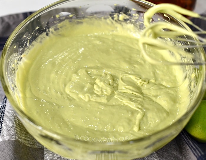 Margarita cake batter beaten together in a large glass bowl. 