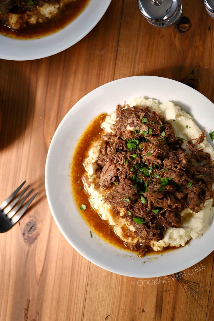 Looking down on a bowl of mashed cauliflower topped with Instant Pot Cafe Mocha Pot Roast.