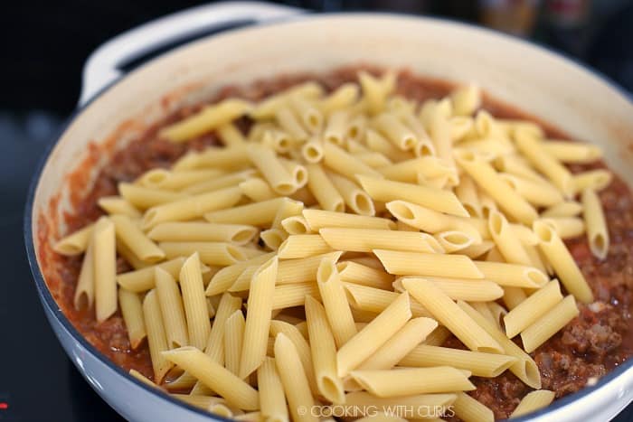 Dry pasta added to the beef mixture in the casserole skillet. 