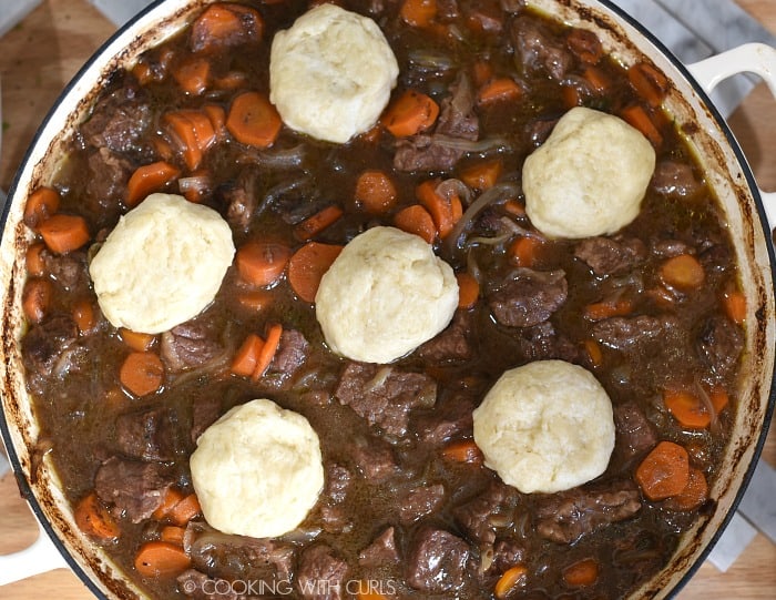 Dumpling balls placed on top of the Guinness Beef in a casserole pan. 