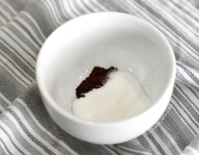 Instant coffee granules and sugar in a small, deep bowl. 