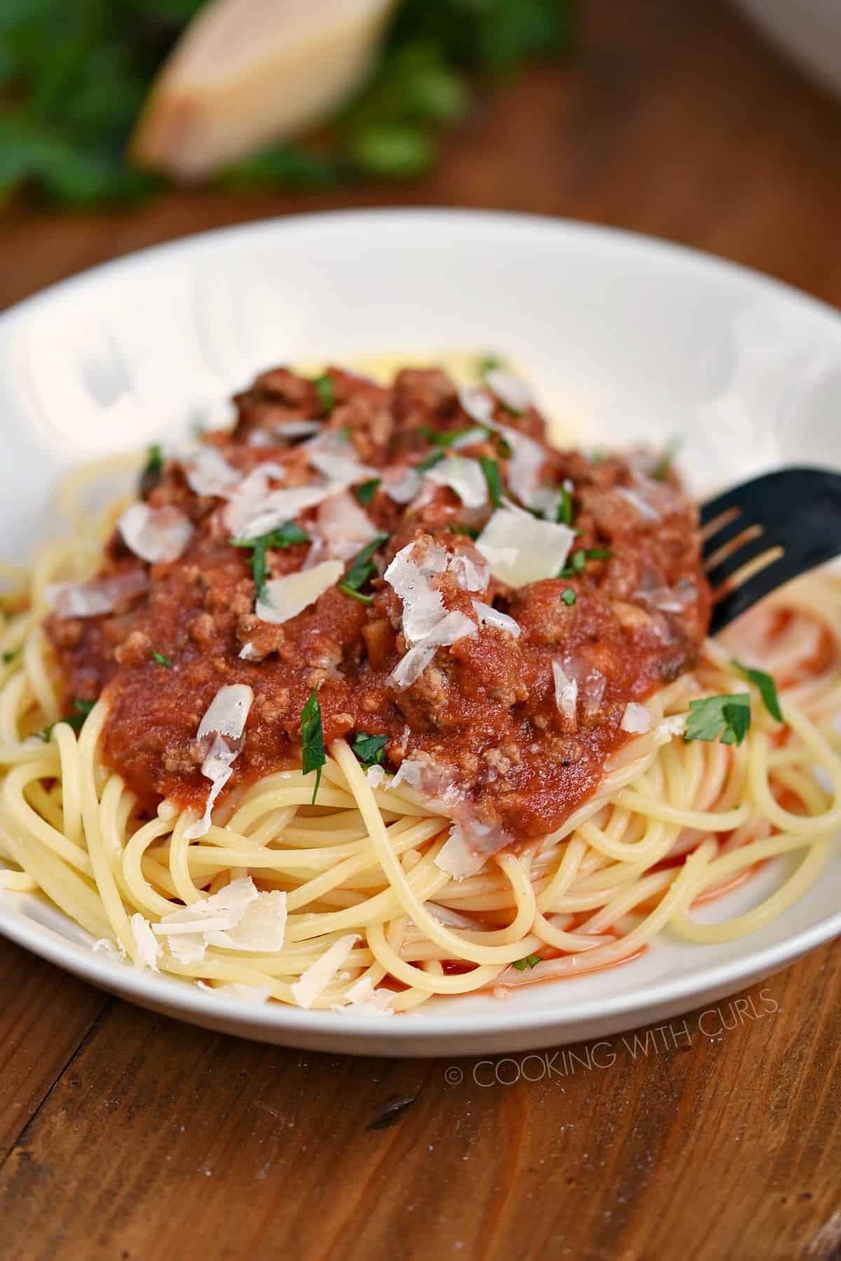Spaghetti noodles topped with Simple Bolognese Sauce and grated Parmesan cheese.