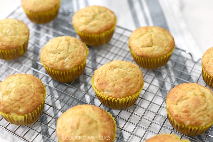 Baked Pina Colada Muffins on a wire cooling rack. 