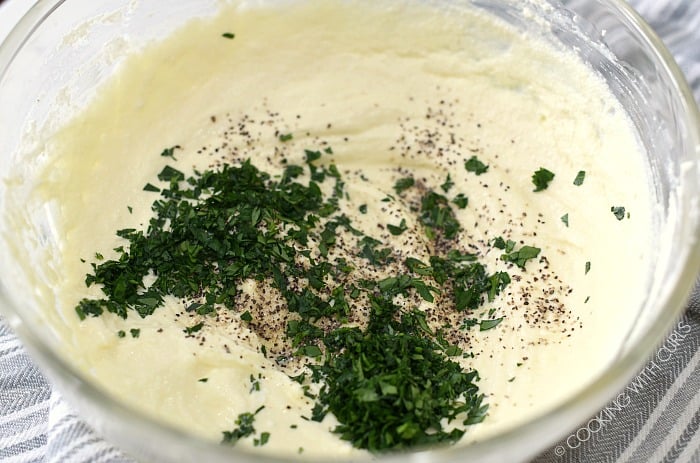 Salt, pepper and parsley added to the ricotta mixture in a large glass bowl. 