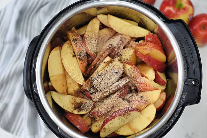 apple wedges, cinnamon sticks, nutmeg and allspice in a pressure cooker.