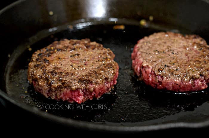 thick, ground steak burger patties in a cast iron skillet. 