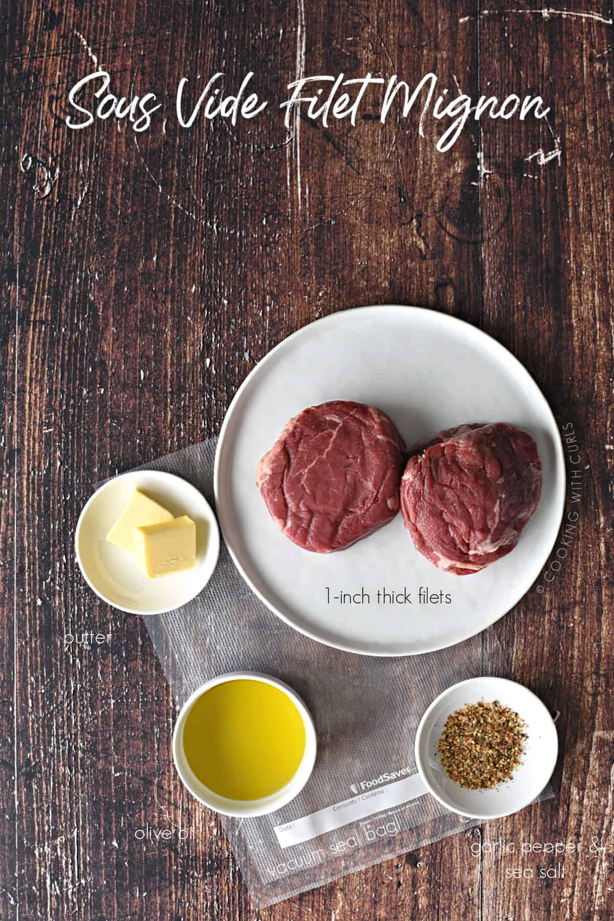 Sous Vide Filet Mignon ingredients; two tablespoons of butter, two tablespoons of olive oil and garlic-pepper and sea salt in small white bowls, a vacuum seal bag and two filets on a white plate.