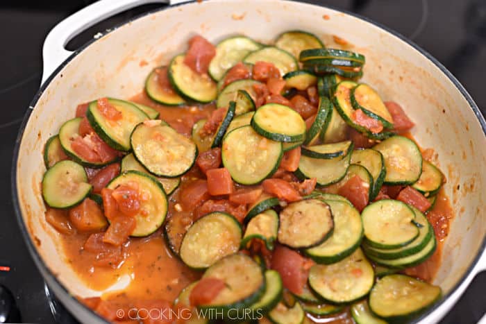 minced garlic and diced tomatoes added to the skillet with the zucchini slices. 