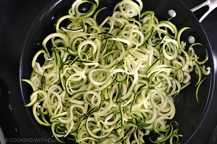 Zucchini noodles in a non-stick pan.