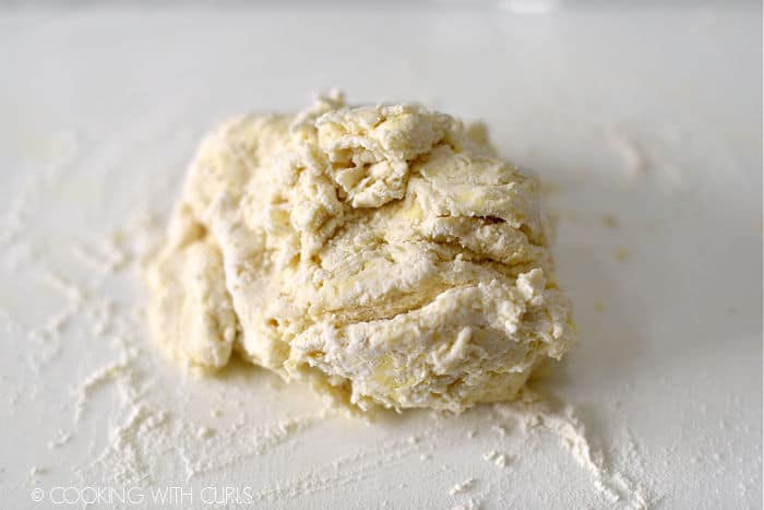 homemade buttermilk biscuit dough on a floured work surface.
