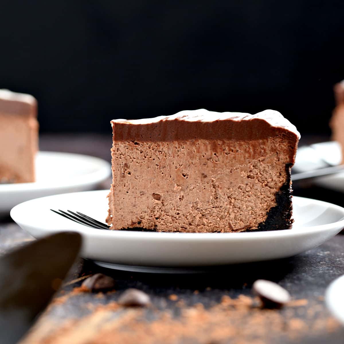 A slice of Instant Pot Chocolate Cheesecake on a white plate.