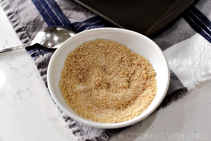 Brown and granulated sugar mixed together in a small white bowl. 