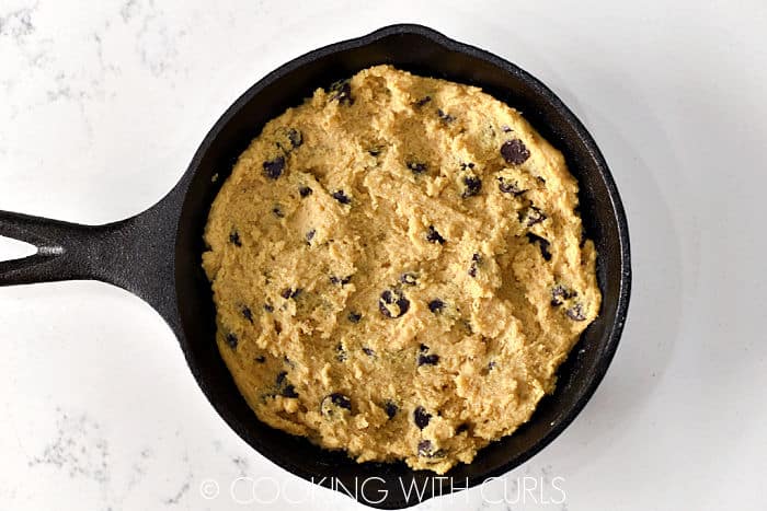 Chocolate Chip Cookie dough in a mini 6.75-inch cast iron skillet. 