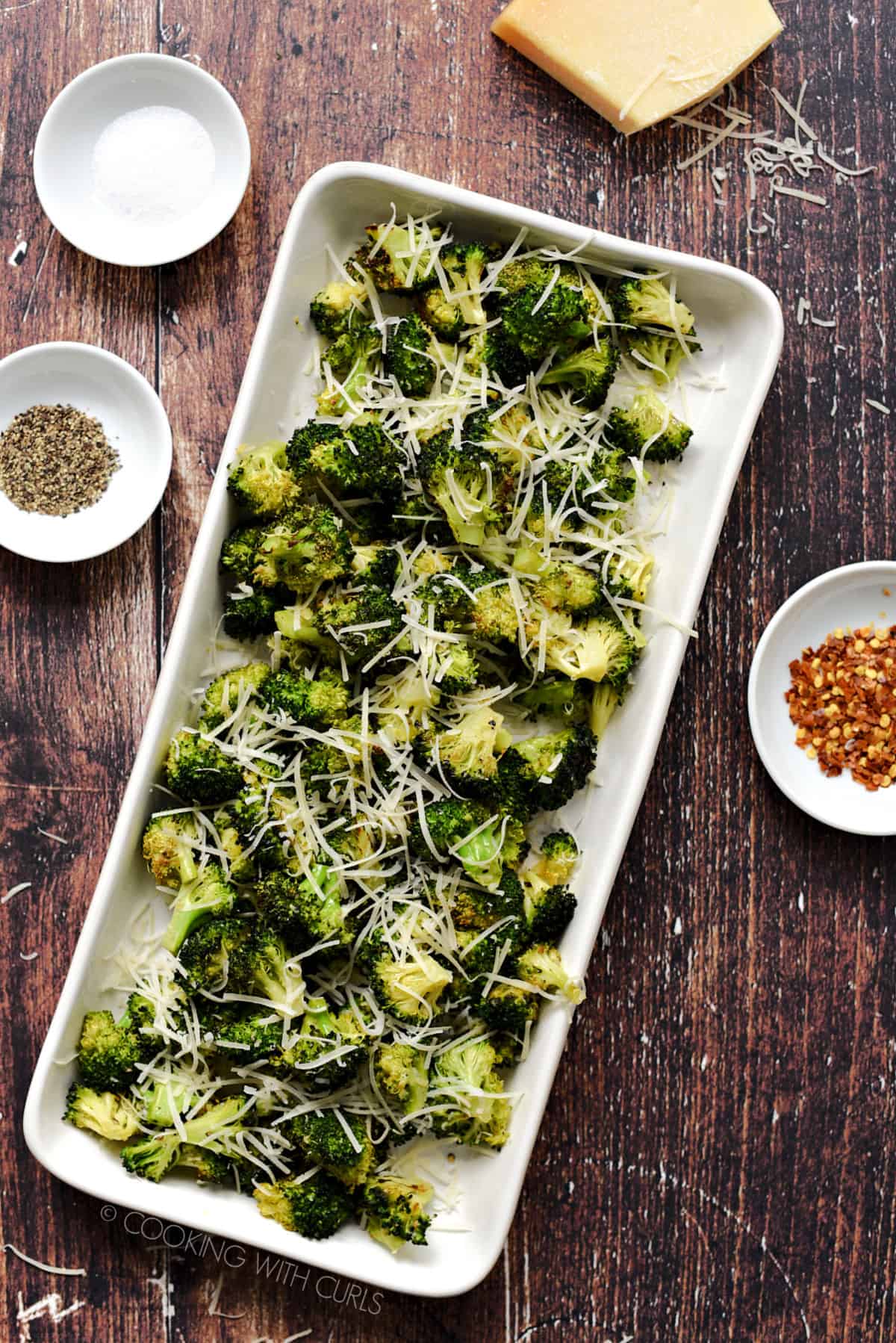 Looking down on Parmesan topped Oven Roasted Broccoli on a rectangle platter.