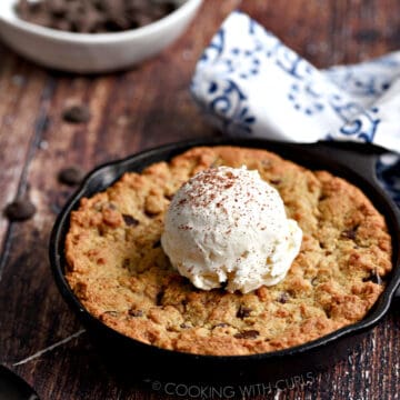 Chocolate Chip Cookie baked in a mini Skillet topped with a scoop of vanilla ice cream.