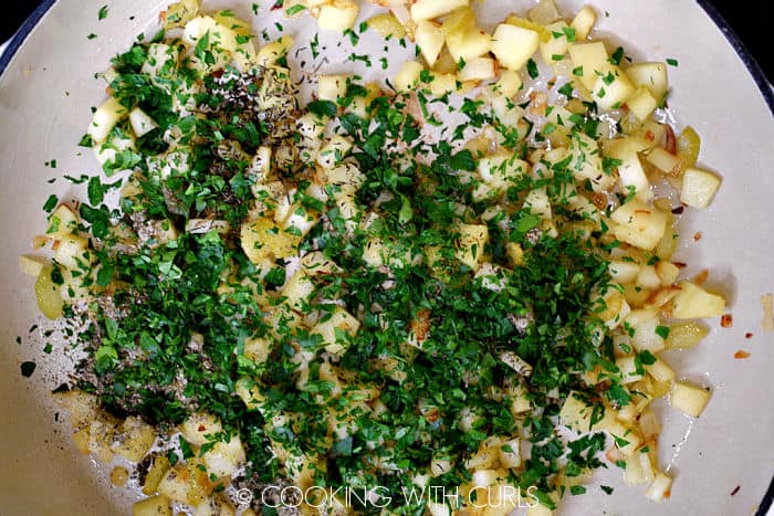Diced apples and chopped parsley added to the onions and celery in the skillet. 