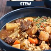 Large chunks of beef, potatoes and carrots surrounded by barley and broth in a blue bowl and title graphic across the top.