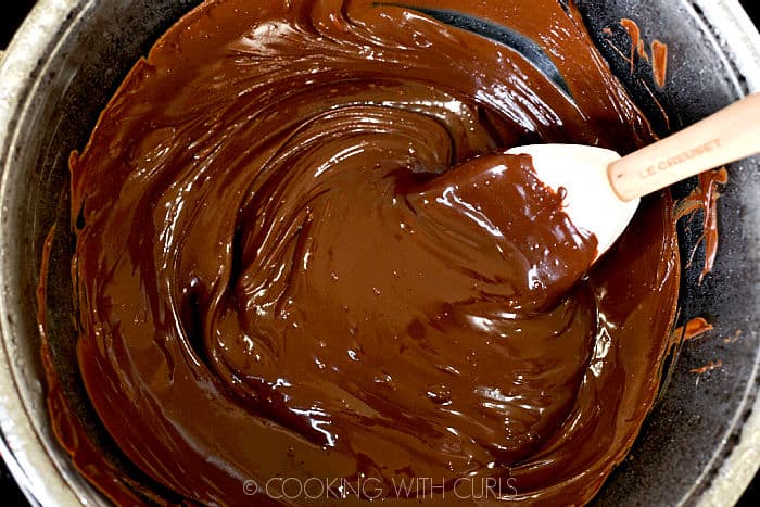 Melted chocolate in a double boiler stirred until smooth with a white silicone spatula. 