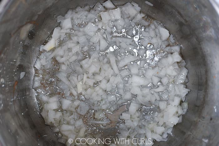 Bacon grease and chopped onion in the pressure cooker. 