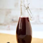 Blackberry Simple Syrup in a glass bottle.
