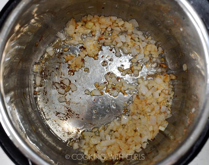 Sautéed onion and garlic in a pressure cooker. 