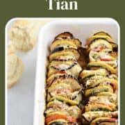 Thin sliced zucchini, squash, eggplant, and tomatoes topped with melted cheese in baking dish.