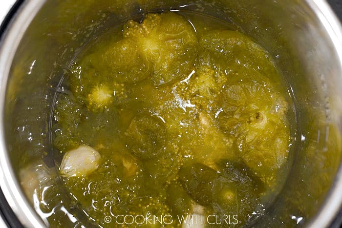 Cooked tomatillos, garlic, and jalapenos in a pressure cooker. 