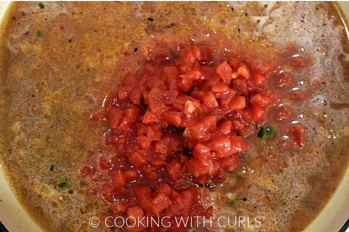 Diced tomatoes and chicken stock in a large skillet. 