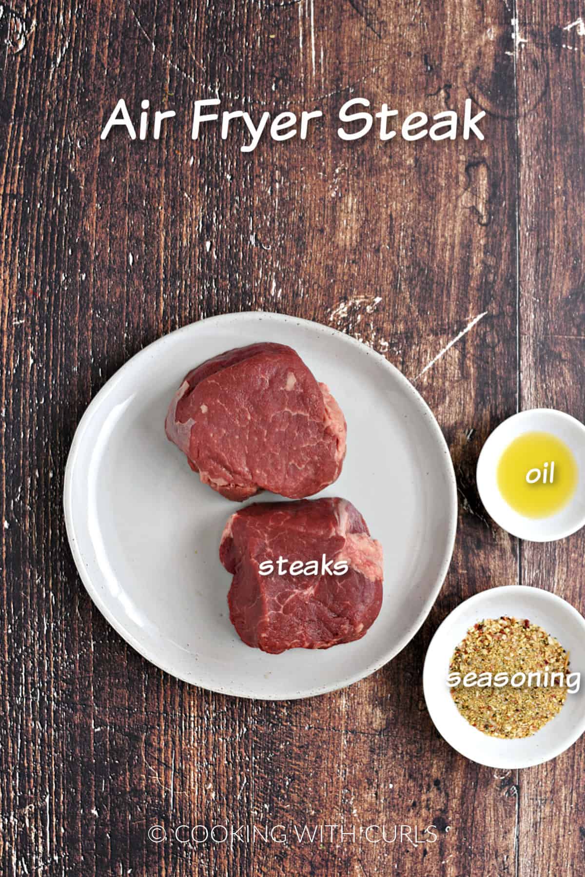 Two steaks on a white plate, a bowl of oil and a bowl of seasoning mix. 