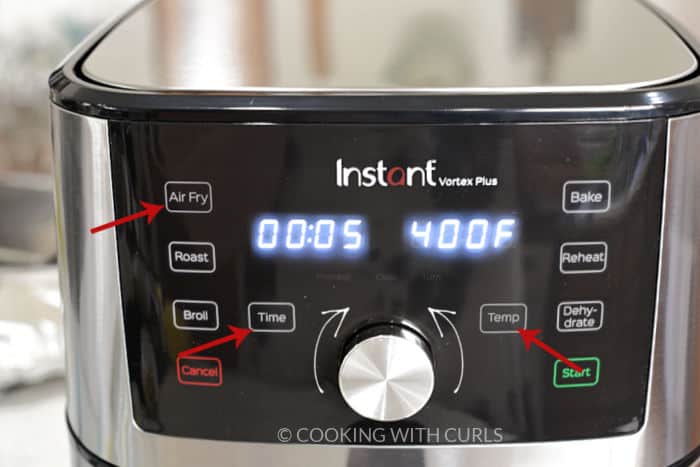 Air Fryer 5 minutes at 400 degrees with arrows pointing to the buttons and knob. 