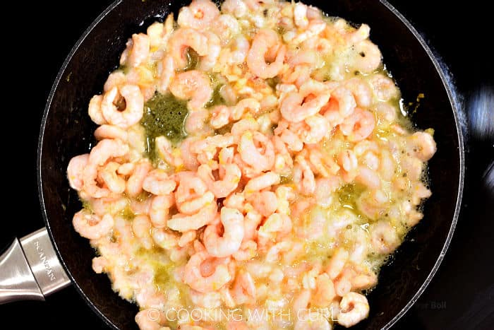 Cocktail shrimp and garlic butter mixture in a small skillet. 