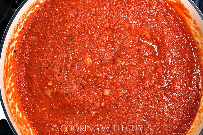 Crushed tomatoes and vodka added to the skillet.