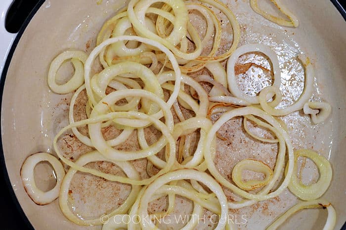 Sliced onions and oil in a skillet. 