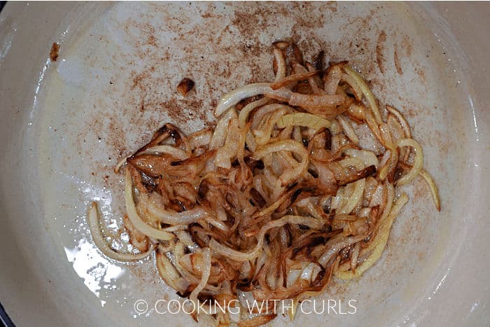 Caramelized onion slices in a large skillet. 