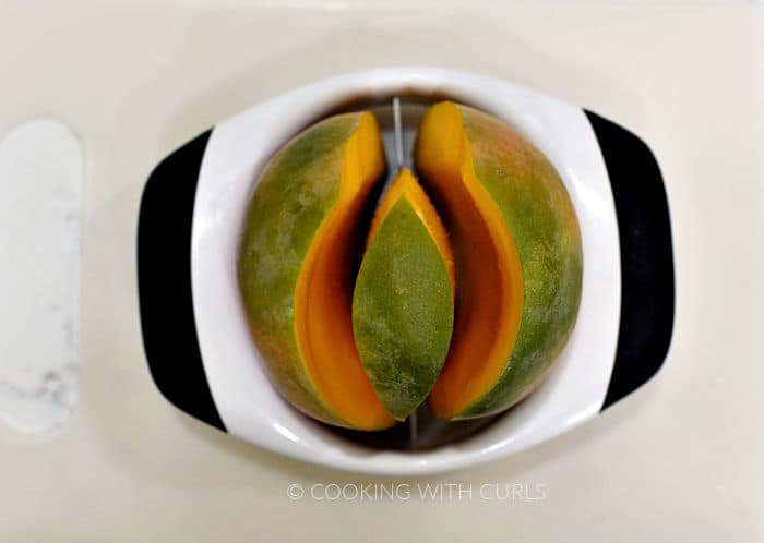 Mango cut with a white plastic mango cutter. 