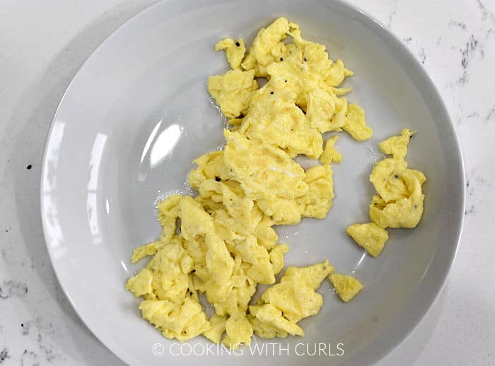 Scrambled eggs on a small plate. 