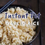 Garlic Rice in a blue bowl with blue chopsticks on the edge and title graphic across the top.