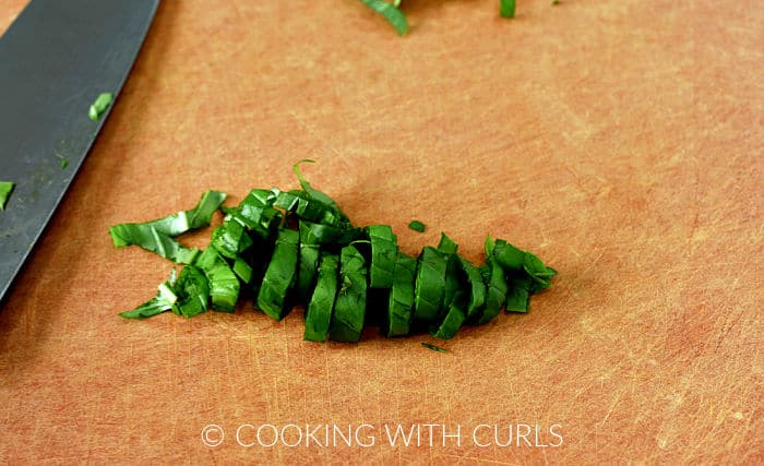 Rolled basil cut into thin strips.