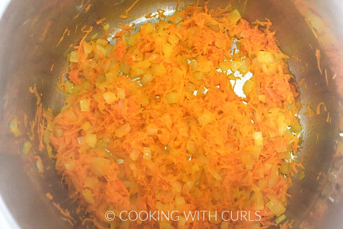 Sautéed onion and carrots in a pressure cooker.
