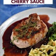 A pork chop sitting on cherry sauce topped with thyme sprigs next to orzo pasta mixed with dried cherries with title graphic across the top.