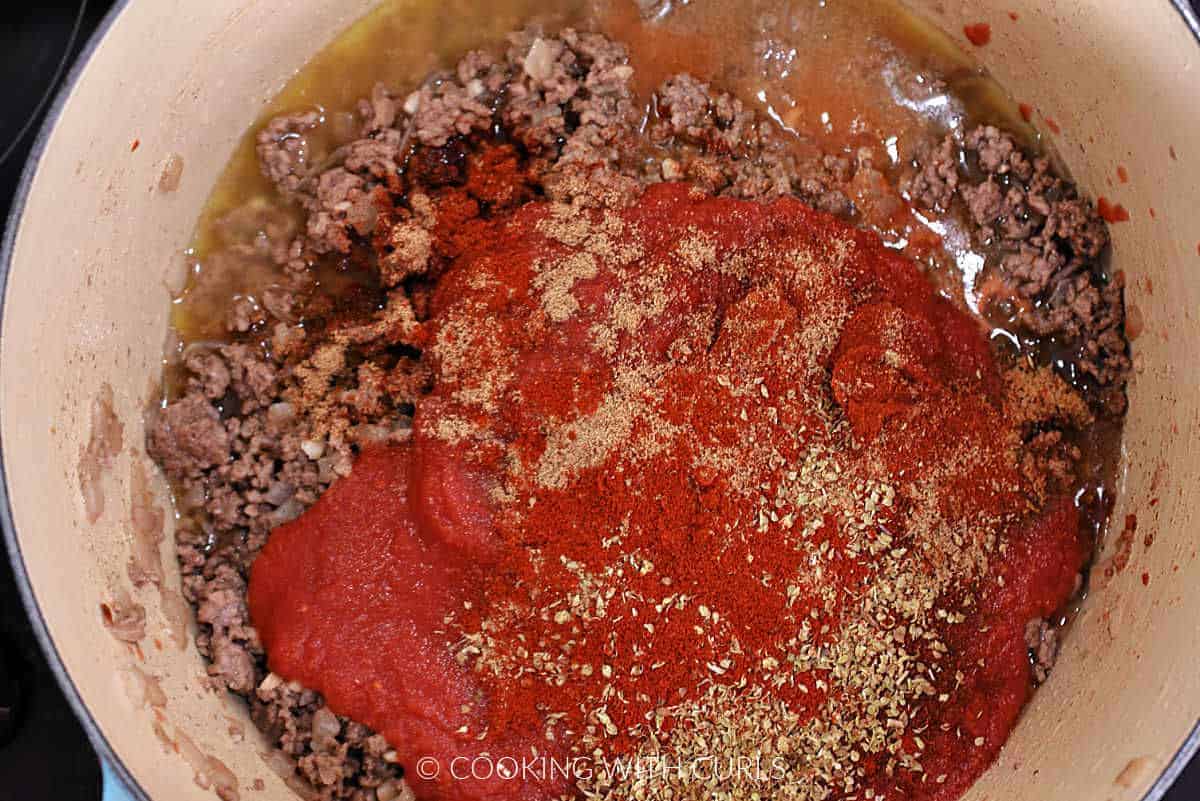 Ground beef, crushed tomatoes, and seasonings in a large pot. 