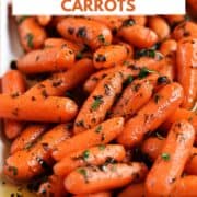 Baby carrots in a honey glaze and topped with chopped parsley on a white platter with title graphic across the top.