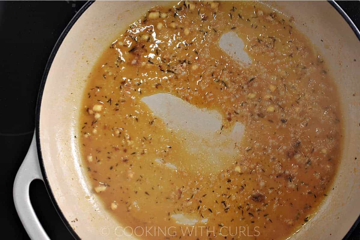 Orange Juice mixed with the garlic and oil in a skillet. 