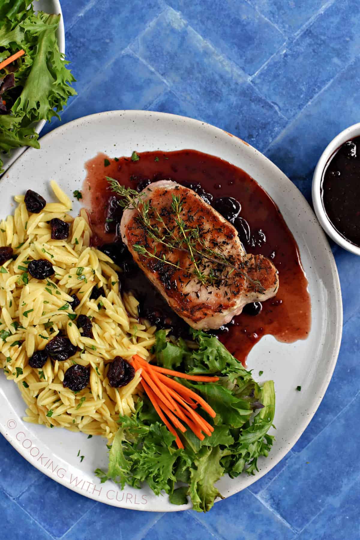 Pork Chops with Cherry Sauce, thyme, salad, and orzo pasta with dried cherries. 